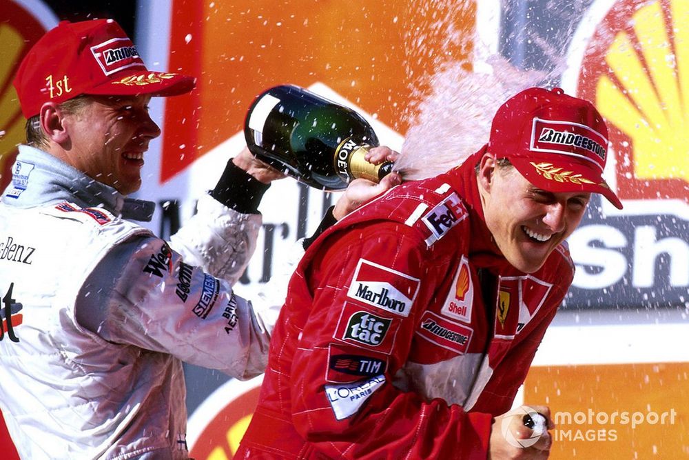 Race winner Mika Hakkinen, Mclaren sprays second placed Michael Schumacher, Ferrari with champagne on the podium