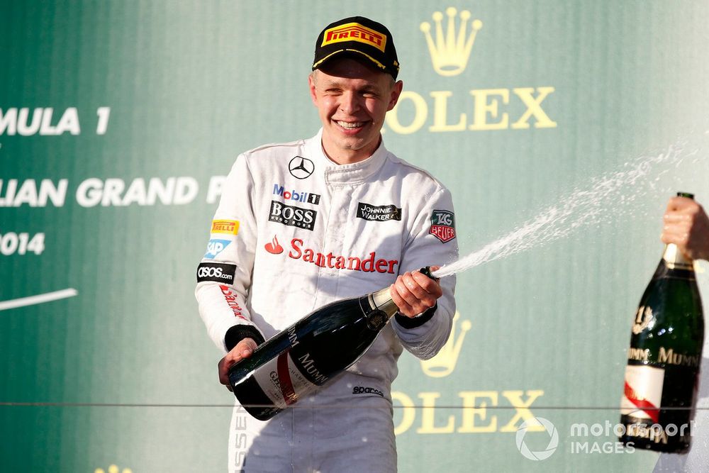 Kevin Magnussen, McLaren, sprays Champagne on the podium