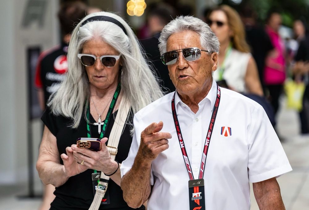 Mario Andretti looks on in the Paddock