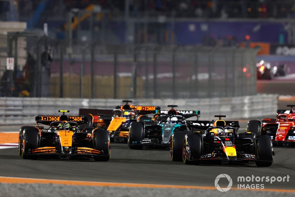 Max Verstappen, Red Bull Racing RB20, overtakes Lando Norris, McLaren MCL38, for the lead of the race