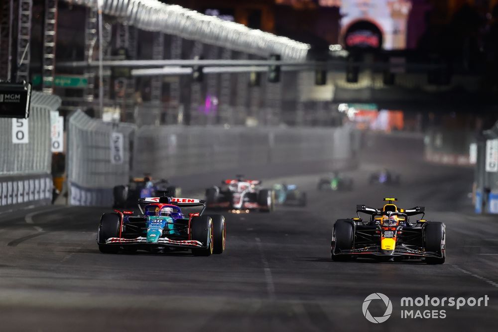 Sergio Perez, Red Bull Racing RB20, battles with Liam Lawson, VCARB 01