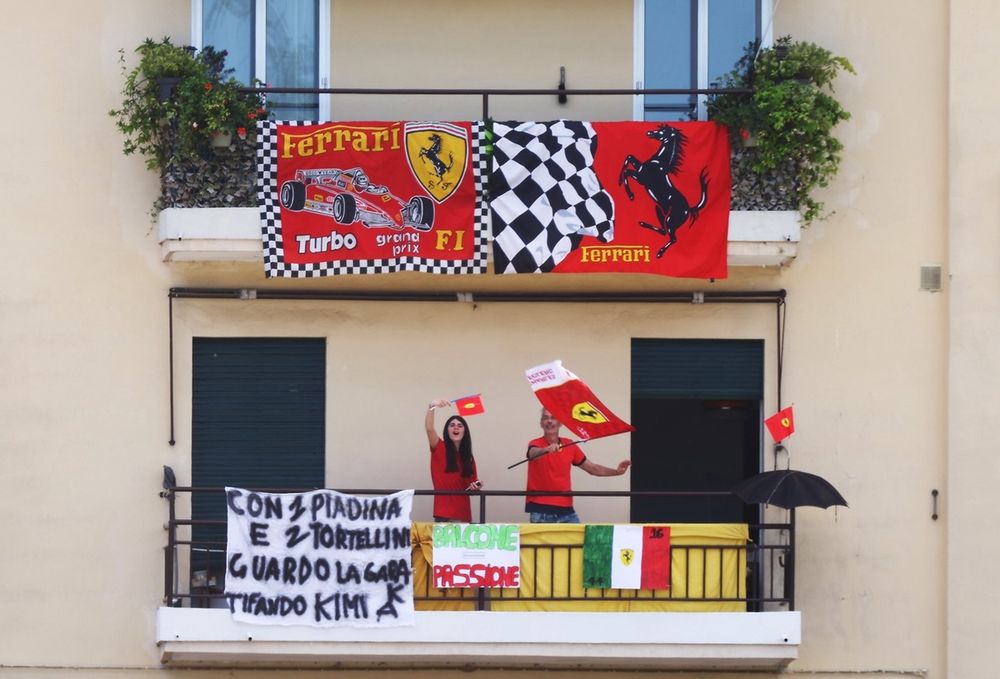 Ferrari fans on a balcony 