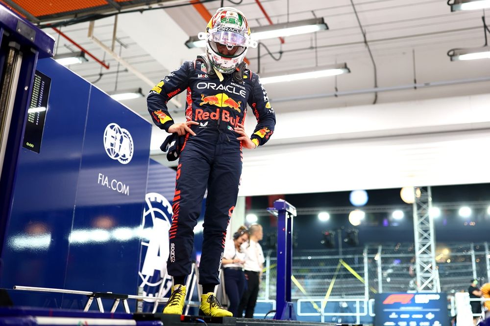Sergio Perez, Red Bull Racing looks on from the FIA garage as he is weighed
