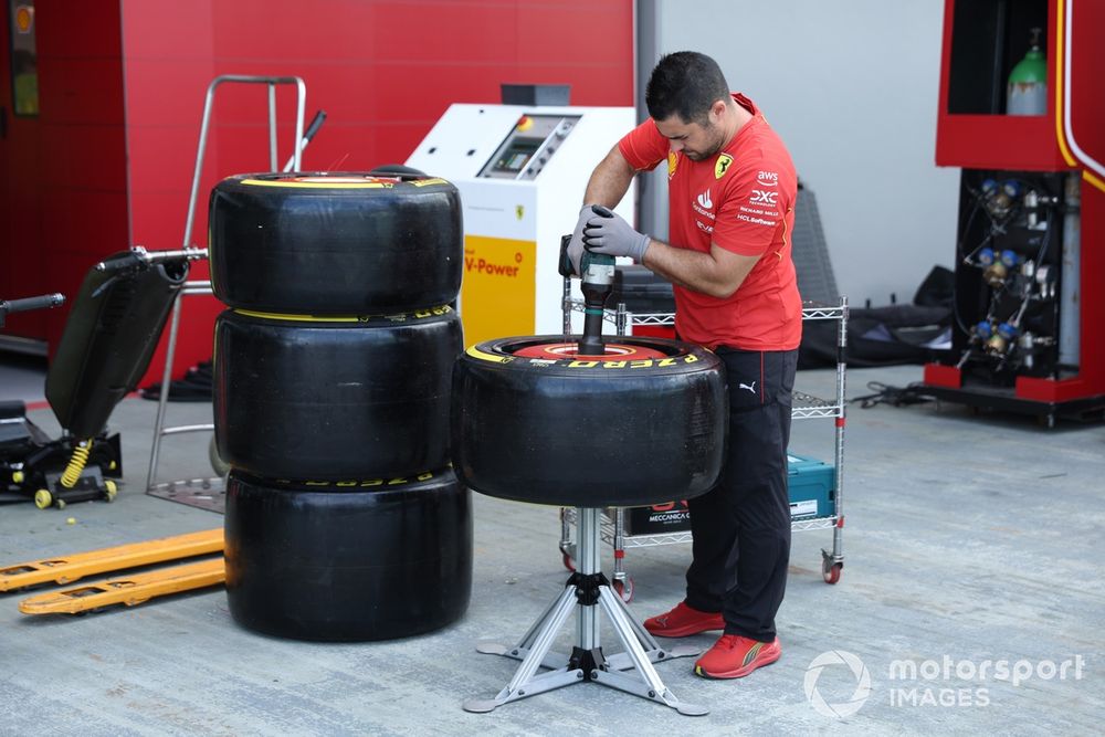 Un meccanico della Scuderia Ferrari lavora sui pneumatici Pirelli