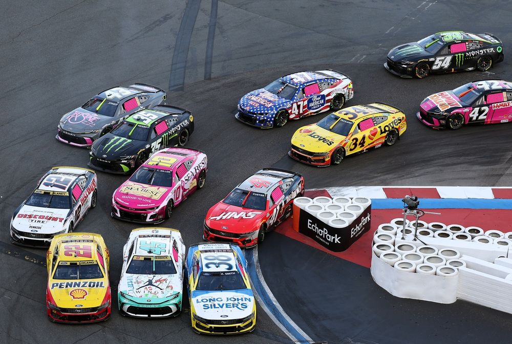 Field races three and four wide through Turn 7 hairpin