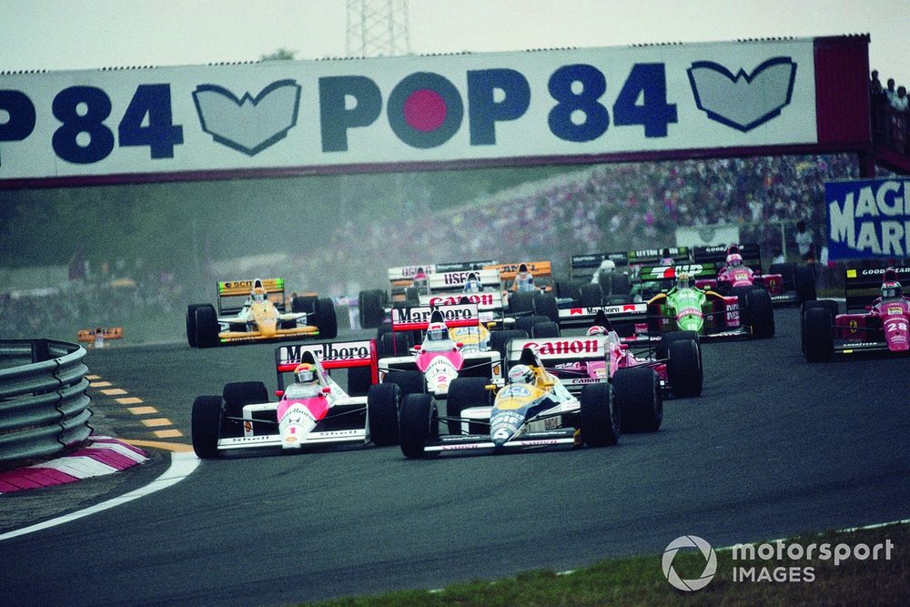 Riccardo Patrese, Williams FW12C Renault, leads Ayrton Senna, McLaren MP4-5 Honda, Alex Caffi, Dallara BMS-189 Ford, and Alain Prost, McLaren MP4-5 Honda, at the star