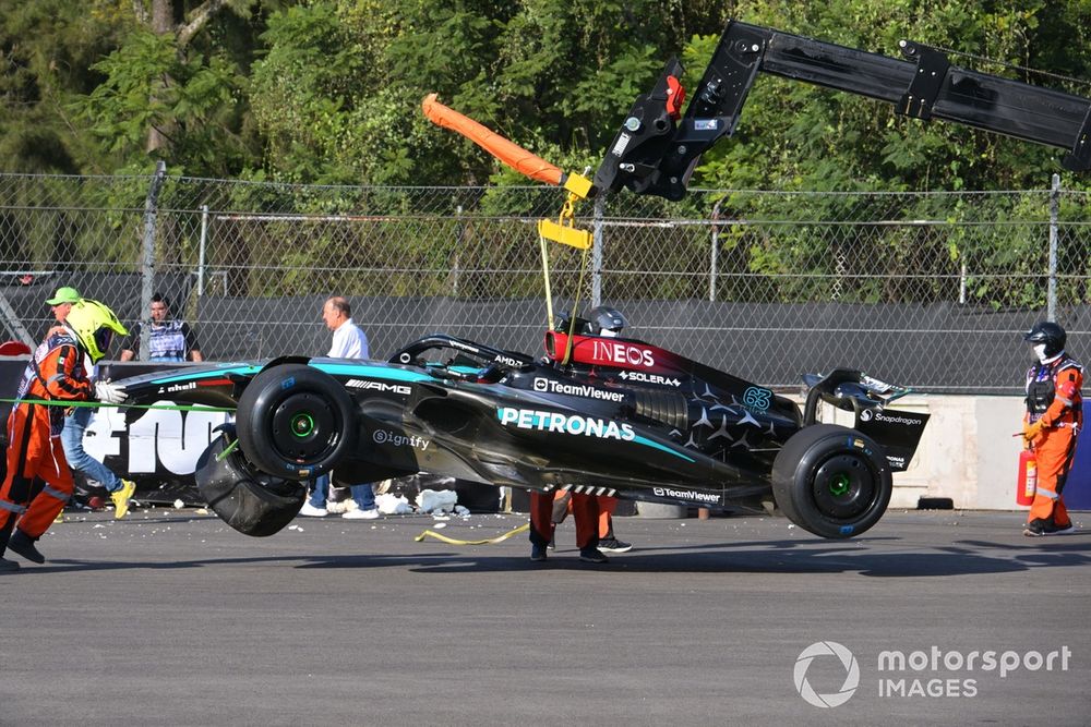Marshals remove the damaged car of George Russell, Mercedes F1 W15, from the circuit after a crash in FP2