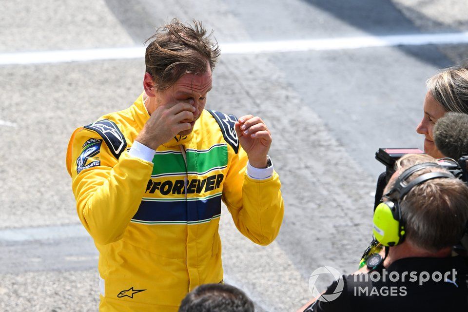 Sebastian Vettel removes his helmet after driving Ayrton Senna's McLaren MP4/8