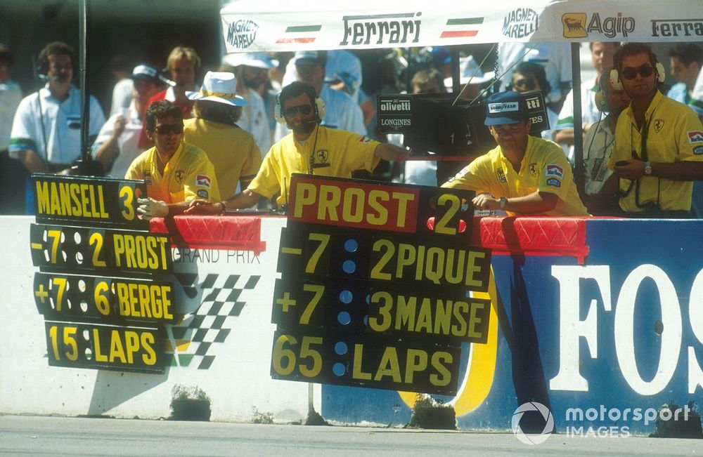 The Ferrari crew hang out the pit boards for their drivers Prost and Mansell