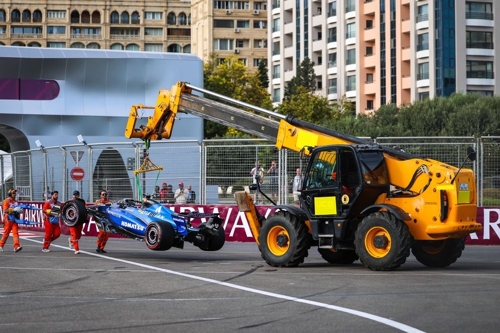 Albon's car is craned away after his Turn 1 wall-clip