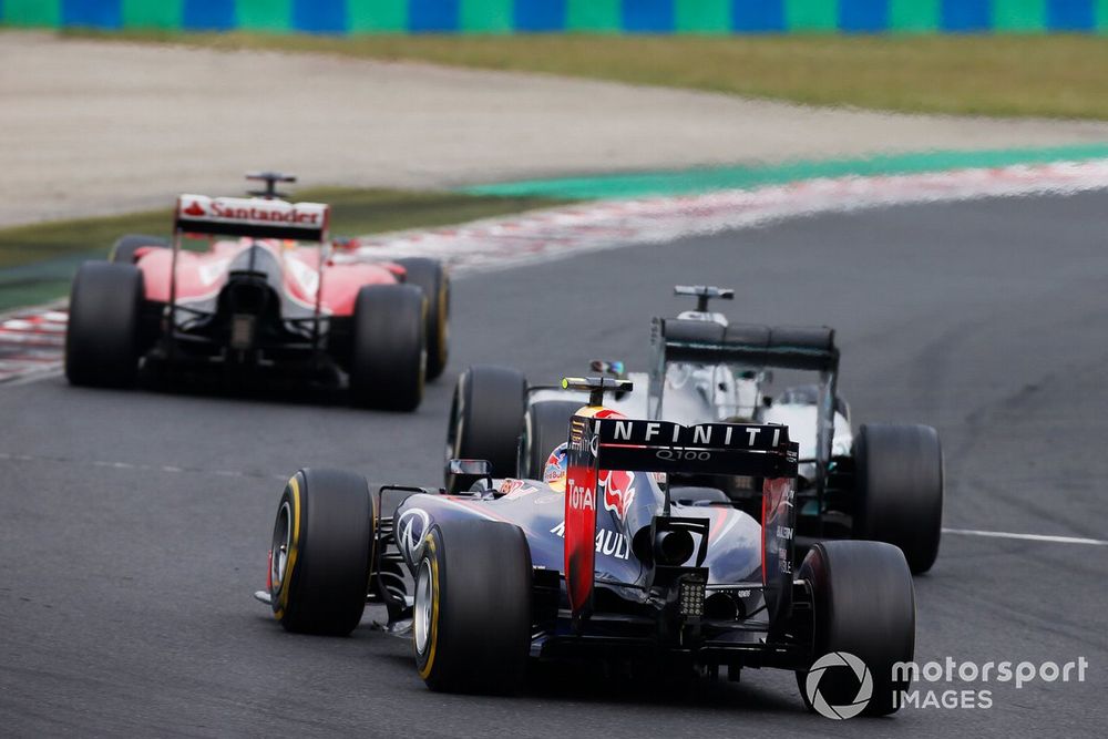 Fernando Alonso, Ferrari F14T, leads Lewis Hamilton, Mercedes F1 W05 Hybrid, and Daniel Ricciardo, Red Bull Racing RB10 Renault