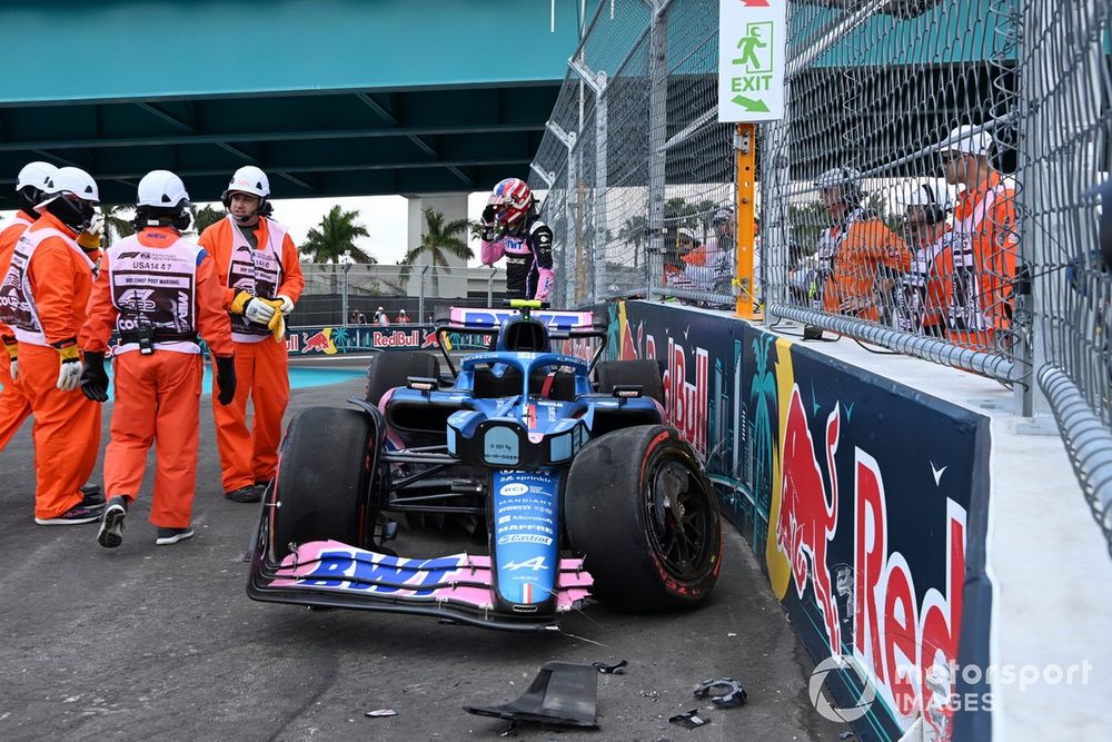 Marshals assist Esteban Ocon, Alpine A522, after a crash