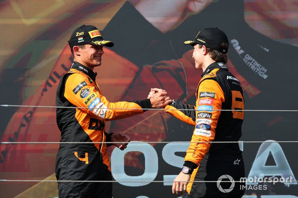 Lando Norris, McLaren F1 Team, 2nd position, and Oscar Piastri, McLaren F1 Team, 1st position, congratulate each other on the podium