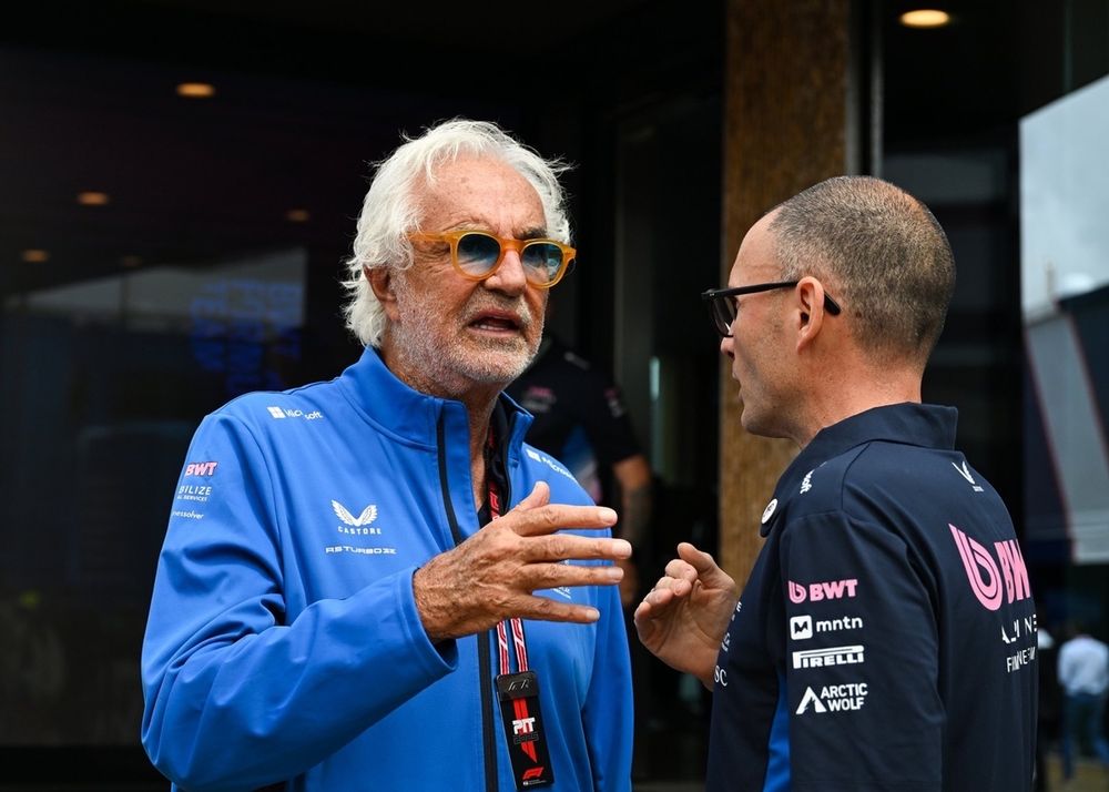 Flavio Briatore, Executive Advisor of Alpine F1 talks with a teammate.