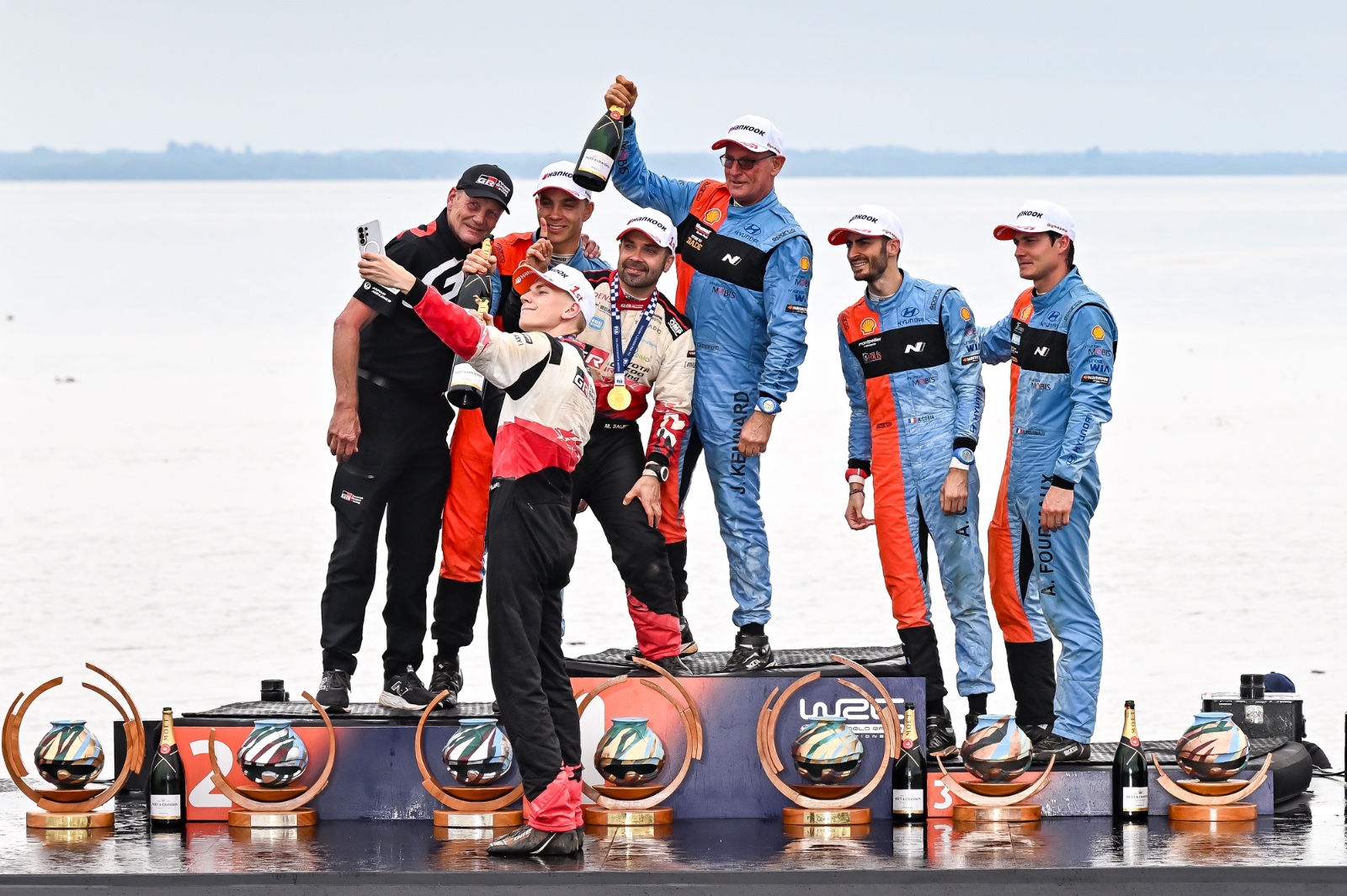 ENCARNACION, PARAGUAY - AUGUST 30: Juha Kankkunen, Sami Pajari and Marko Salminen of Finland and Toyota Gazoo Racing WRT, Hayden Paddon and John Kennard of New Zealand and Adrien Fourmaux and Alexandre Coria of France representing Hyundai World Rally Team celebrate at the finish podium during Rally del Paraguay, Round 11 of the 2026 FIA World Rally Championship on August 30, 2026 in Encarnacion, Paraguay