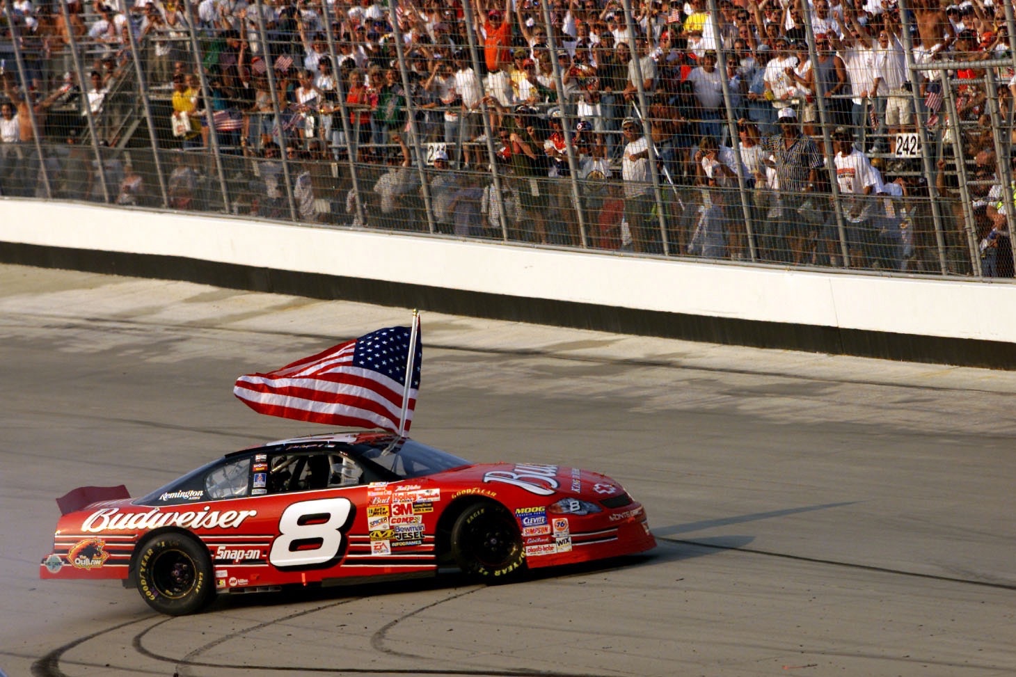 23 Sep 2001: Dale Earnhardt Jr. carries a flag as he burns the tires of his #8 Budweiser Cheverolet Monte Carlo following his win in the MBNA-Cal Ripken Jr. 400 at Dover Downs International Speedway in Dover, Delaware.